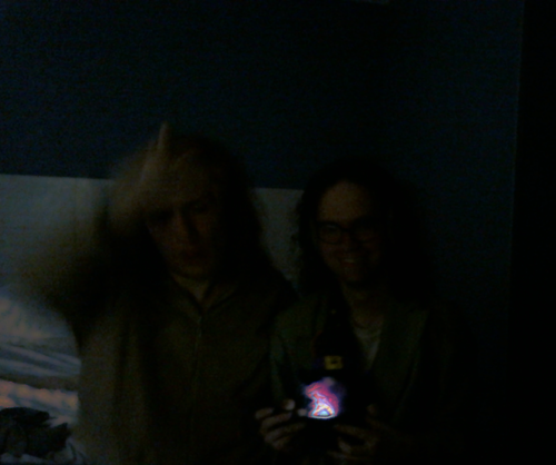 We're in the dark, but it's light
behind us, kind of like we're in a park with white concrete, but
the ground is bedding, and there's a kind of unearthly purple
flame we're like conjuring and presenting to the viewer, and a
tiny gnome with a buckle hat is peeking out from behind it, and
the light is scattering in a kind of silky impossible glittery
way on the bedding behind us in front of the concrete wall
